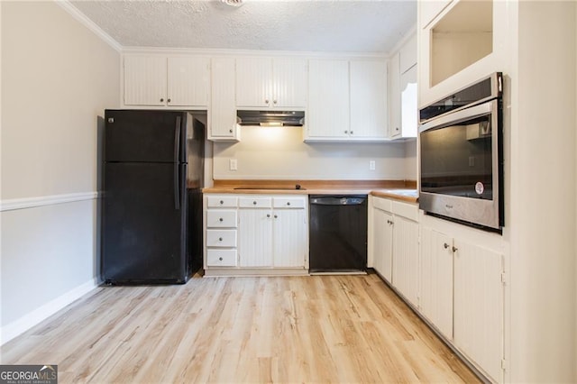 kitchen featuring crown molding, light hardwood / wood-style floors, a textured ceiling, white cabinets, and black appliances