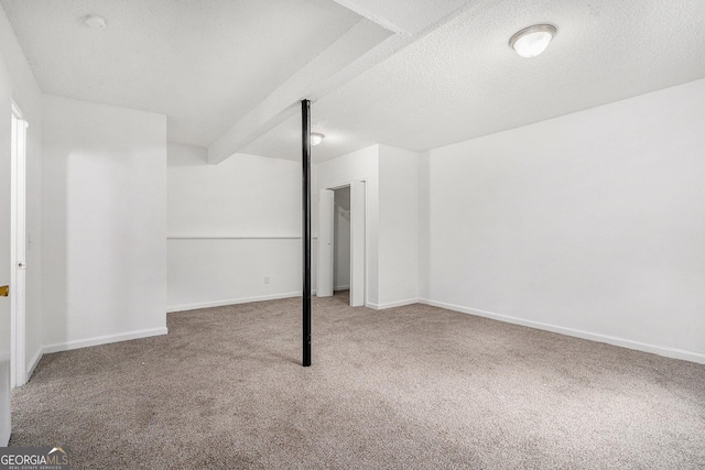 basement with carpet flooring and a textured ceiling