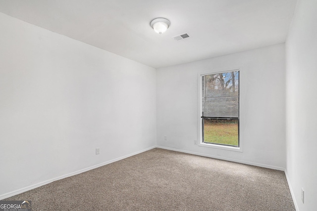 carpeted spare room featuring plenty of natural light