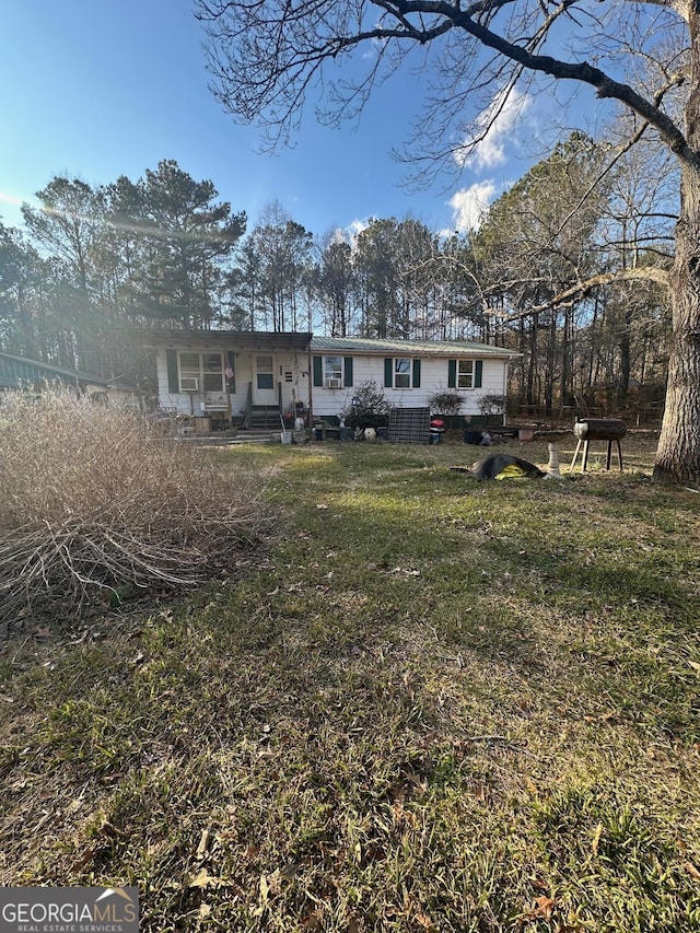 back of property featuring a yard