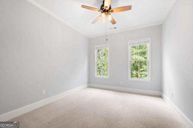 carpeted spare room featuring crown molding and ceiling fan