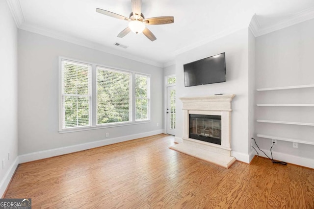 unfurnished living room featuring hardwood / wood-style flooring, ceiling fan, and ornamental molding