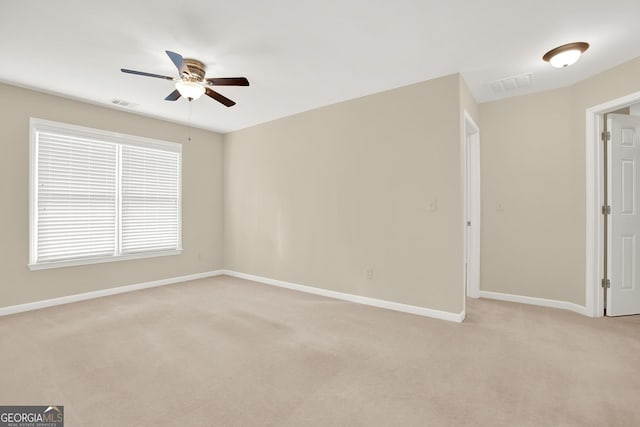 carpeted spare room with ceiling fan