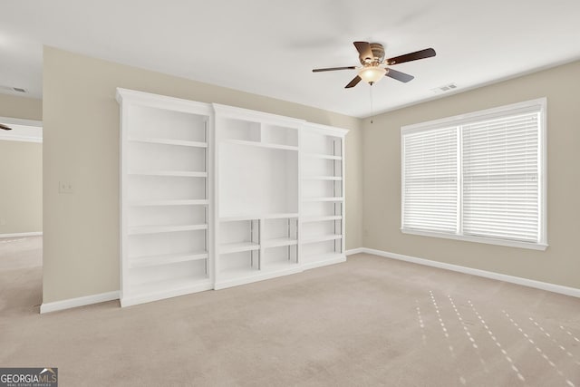 interior space featuring light carpet and ceiling fan