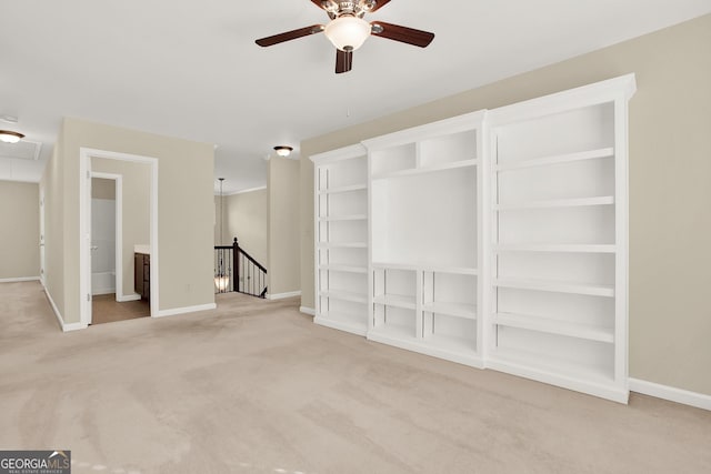 empty room featuring ceiling fan and carpet