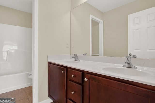 bathroom featuring tile patterned floors, vanity, and toilet