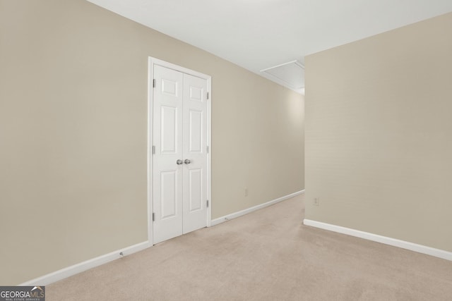 spare room featuring light colored carpet