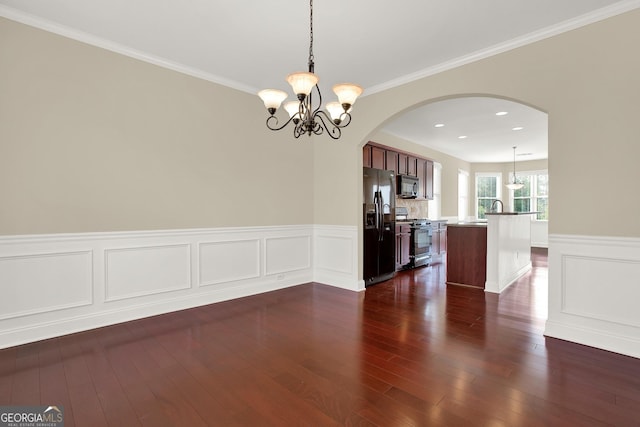 interior space with ornamental molding, dark wood-type flooring, a notable chandelier, and sink