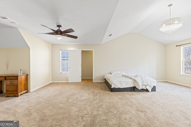 bedroom featuring vaulted ceiling, ceiling fan with notable chandelier, carpet flooring, and baseboards