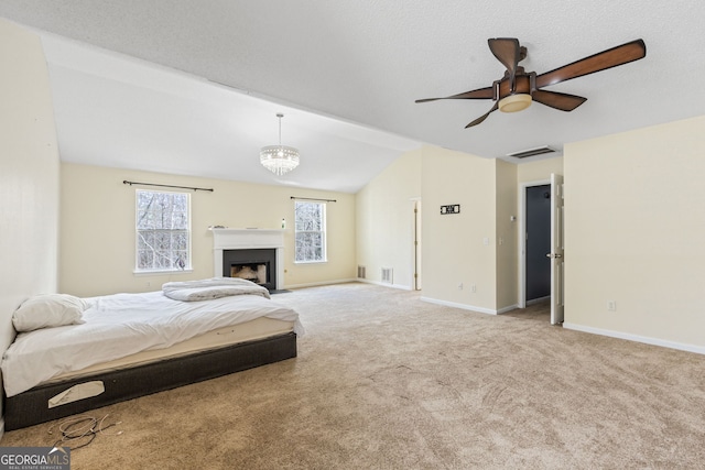 bedroom featuring carpet floors, visible vents, vaulted ceiling, baseboards, and ceiling fan with notable chandelier