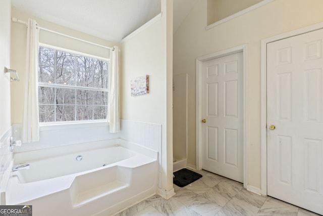 bathroom with marble finish floor, a stall shower, and a bath