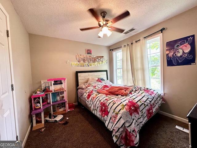 bedroom with a textured ceiling and ceiling fan