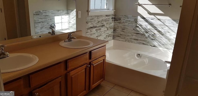 bathroom with a bathing tub, tile patterned flooring, and vanity