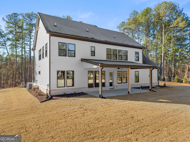 rear view of house with a lawn, ceiling fan, a patio, and central AC