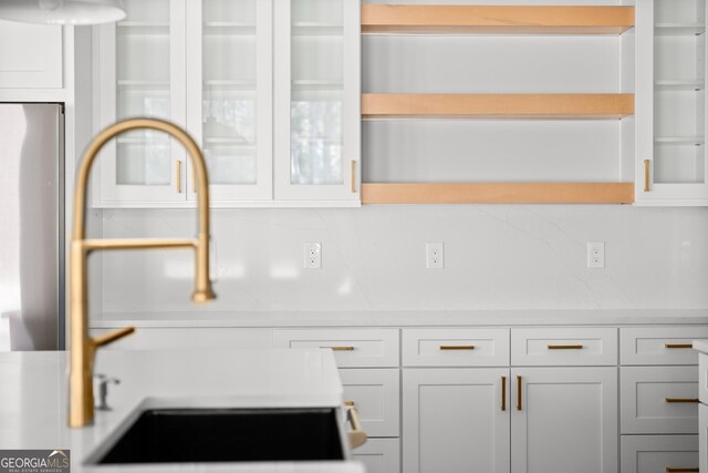 interior details with white cabinets and sink