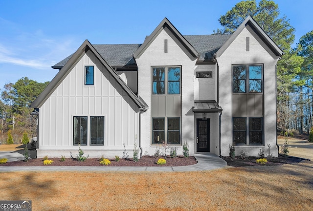 modern inspired farmhouse featuring a front lawn