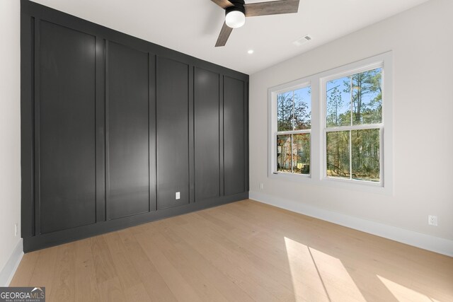 unfurnished bedroom with ceiling fan and light wood-type flooring