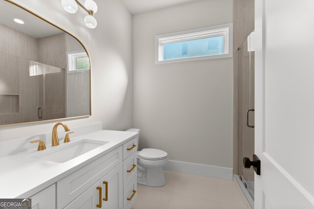 bathroom featuring plenty of natural light, an enclosed shower, and vanity