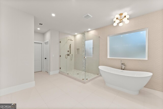 bathroom with separate shower and tub and tile patterned floors