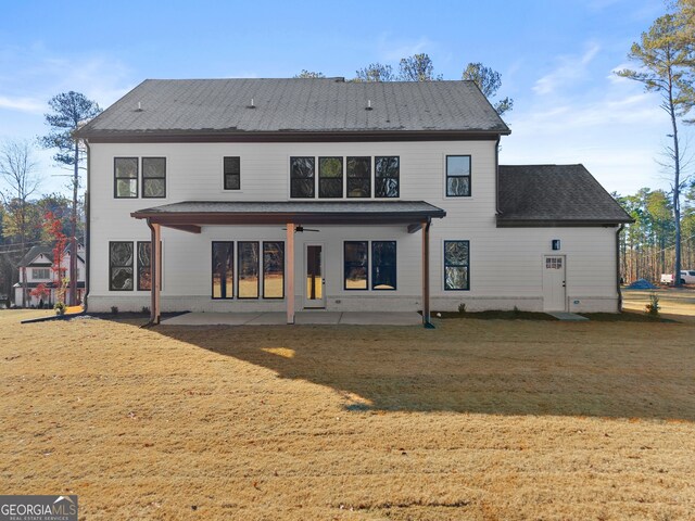 back of house featuring ceiling fan, a patio area, and a yard