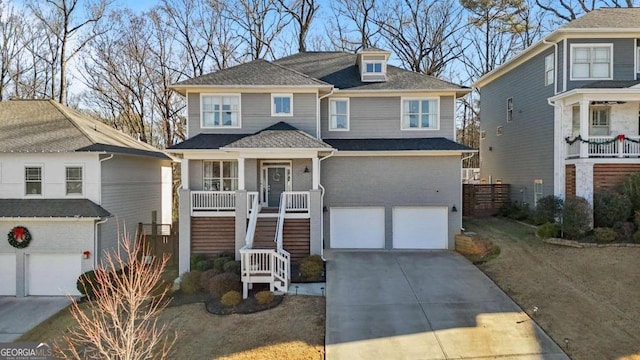 view of property with a garage, a porch, and a front yard