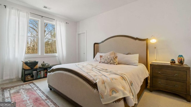 bedroom with light colored carpet