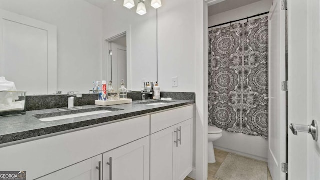 full bathroom with vanity, toilet, and shower / tub combo with curtain