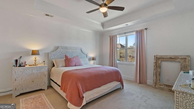 bedroom featuring a tray ceiling and ceiling fan