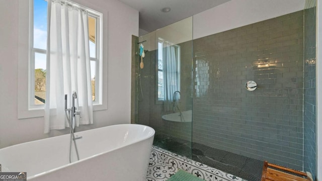 bathroom featuring shower with separate bathtub, tile patterned floors, and plenty of natural light