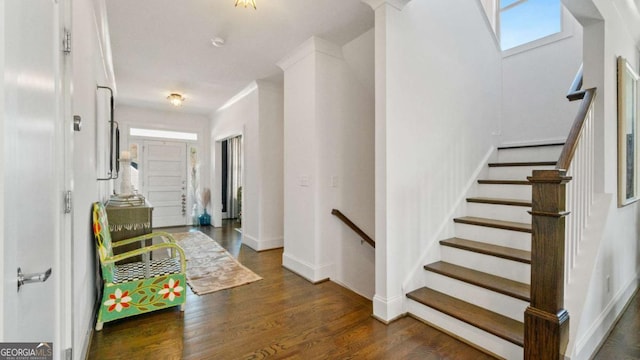 foyer with crown molding and dark hardwood / wood-style flooring