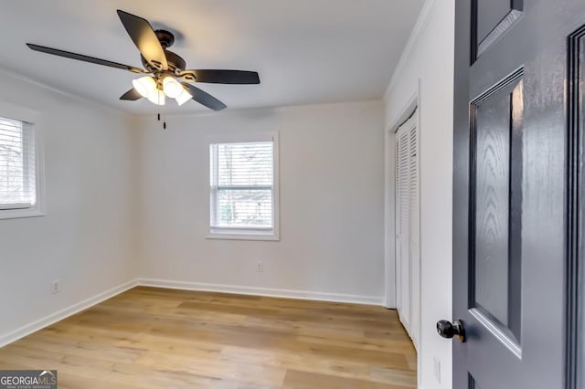 unfurnished room with ceiling fan, light hardwood / wood-style floors, and ornamental molding