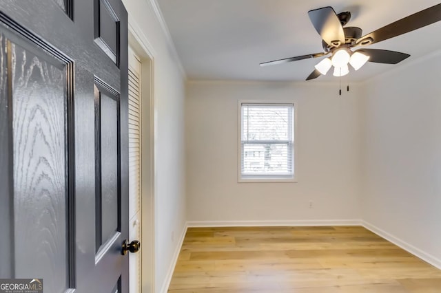 unfurnished room with ceiling fan, light hardwood / wood-style floors, and crown molding