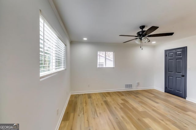 unfurnished room featuring ceiling fan, a healthy amount of sunlight, and light hardwood / wood-style flooring