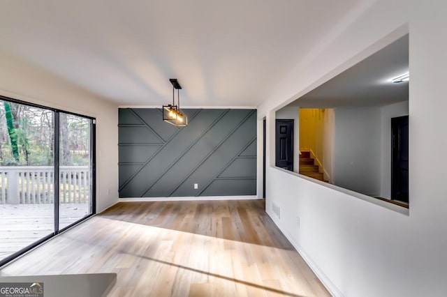 unfurnished dining area with light hardwood / wood-style floors