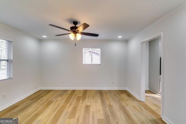 empty room featuring ceiling fan, light hardwood / wood-style flooring, and crown molding