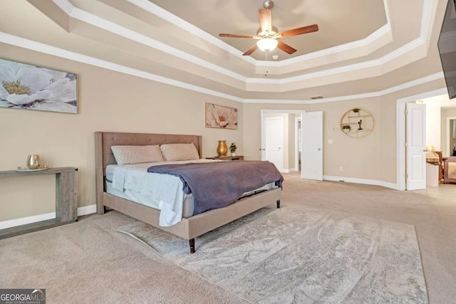 bedroom with ceiling fan, crown molding, light carpet, and a tray ceiling