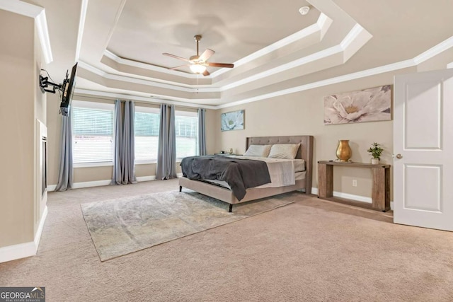 bedroom with a raised ceiling, ceiling fan, light carpet, and ornamental molding