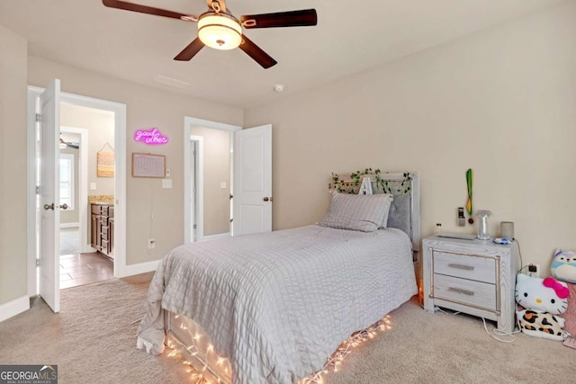 bedroom featuring ensuite bath, ceiling fan, and light colored carpet