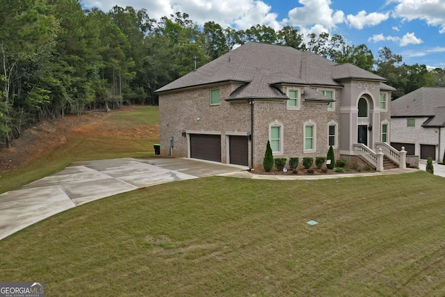 view of front of home with a garage and a front lawn