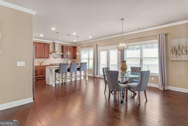 dining room featuring a healthy amount of sunlight, dark hardwood / wood-style flooring, and ornamental molding