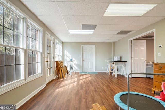 miscellaneous room featuring a paneled ceiling and hardwood / wood-style floors