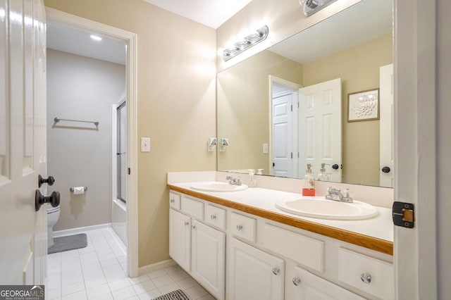 full bathroom with tile patterned floors, vanity, enclosed tub / shower combo, and toilet