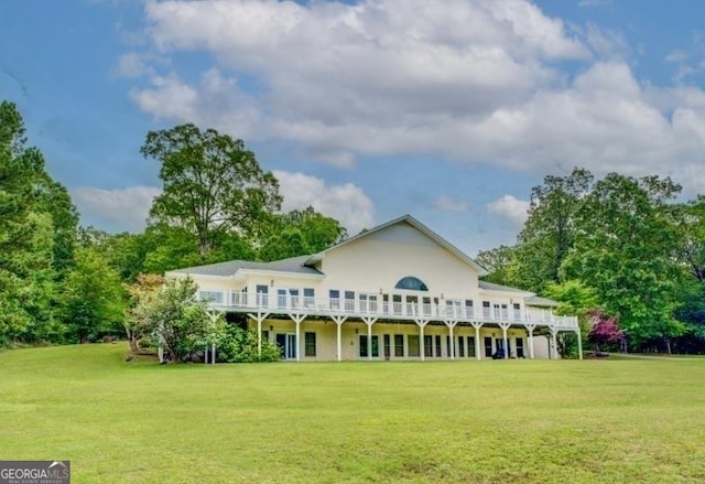 back of property featuring a yard