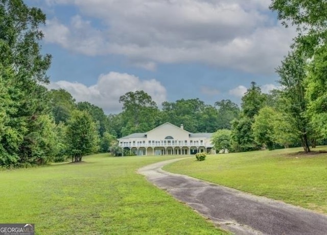 surrounding community featuring a yard