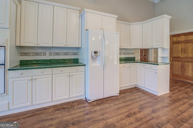 kitchen featuring white cabinetry, white appliances, backsplash, and dark wood-type flooring