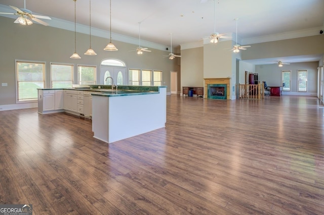 kitchen featuring white cabinetry, hanging light fixtures, a wealth of natural light, and dark wood-type flooring