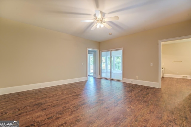 unfurnished room featuring ceiling fan and dark wood-type flooring