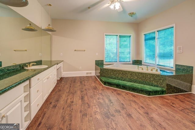 bathroom featuring hardwood / wood-style flooring, a washtub, ceiling fan, and vanity