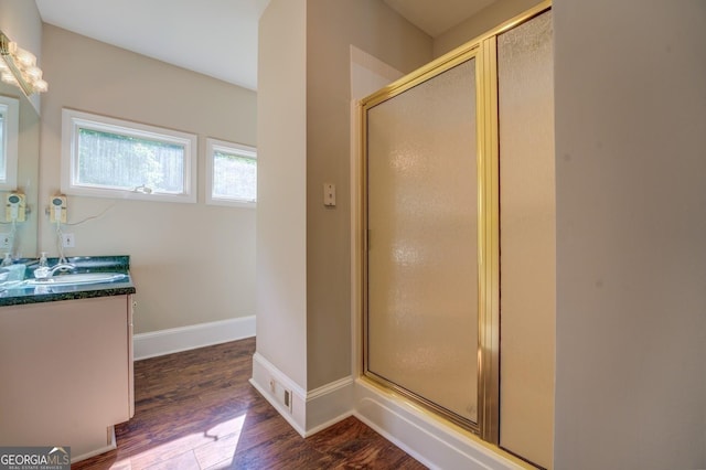 bathroom featuring vanity, an enclosed shower, and hardwood / wood-style flooring