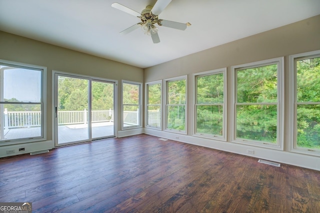 unfurnished sunroom with ceiling fan